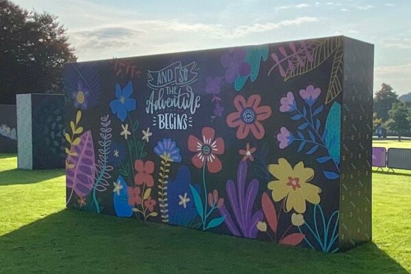 Large super-graphic photo backdrop at Leeds Beckett graduation ceremony